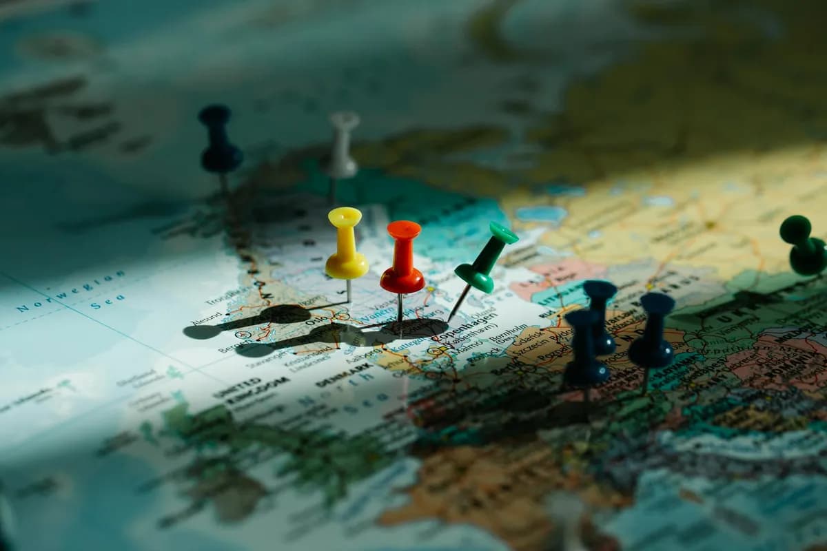 Push pins marking travel destinations on a world map for trip planning