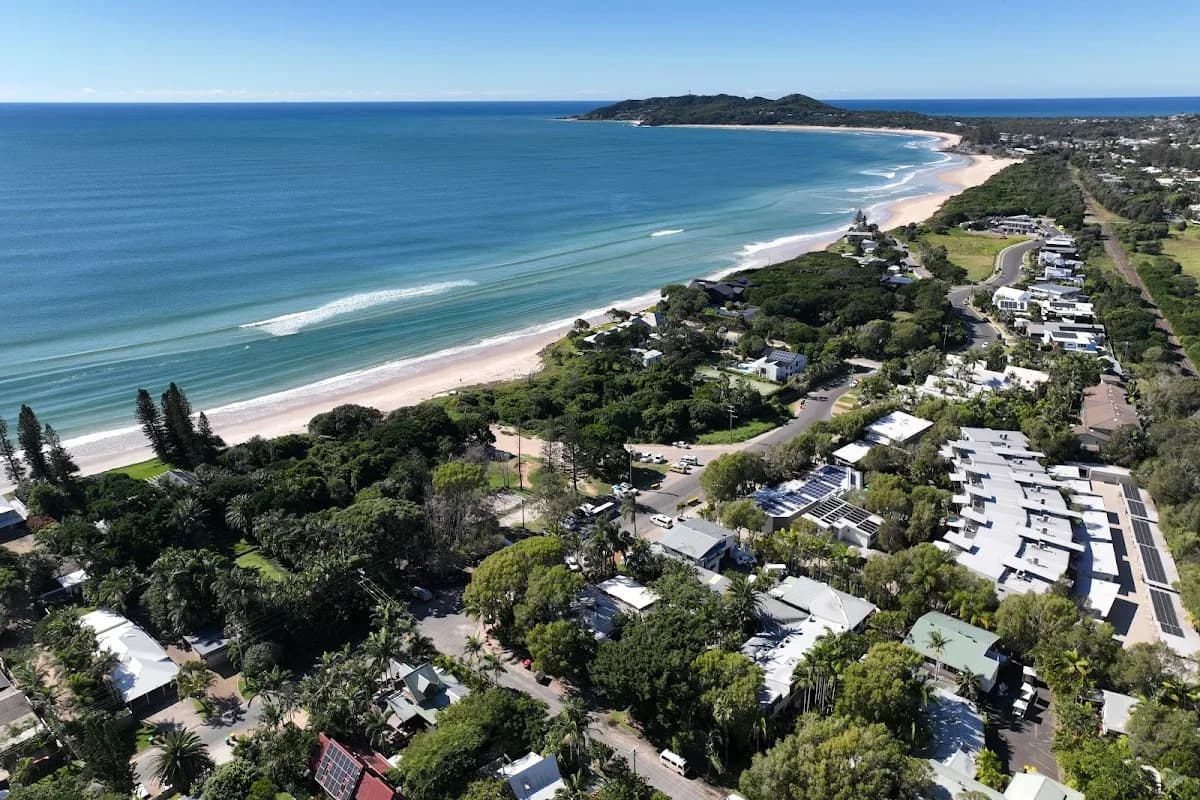 Backpacker hostels in Australia — aerial view of Byron Bay, NSW with hostel accommodation along the coast