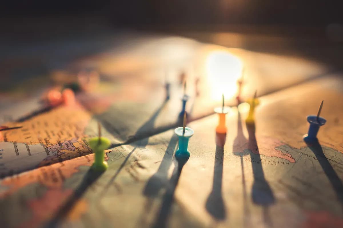 Trip planning with colourful pins on a road map