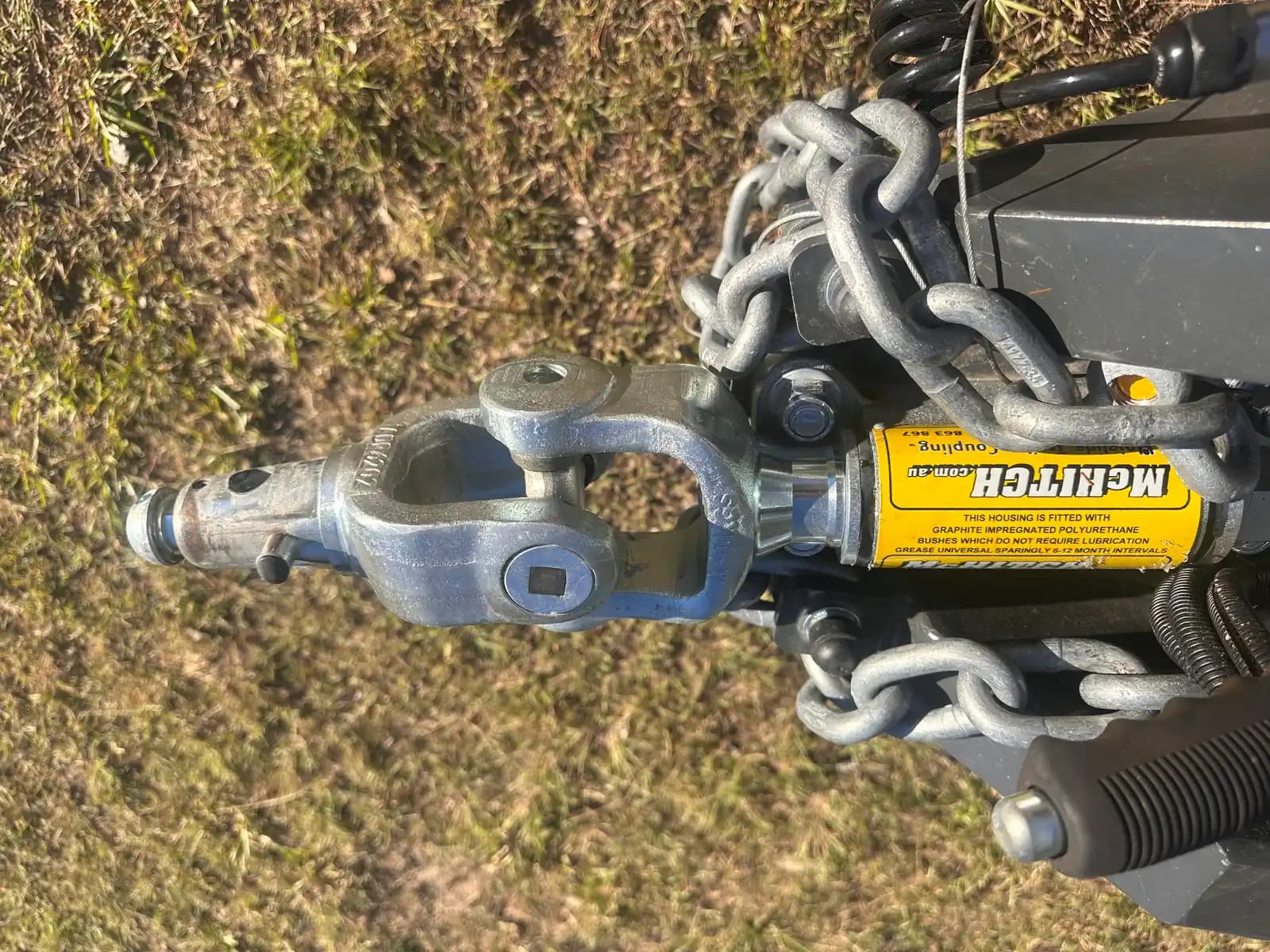 McHitch coupling unit with branding label and safety chains