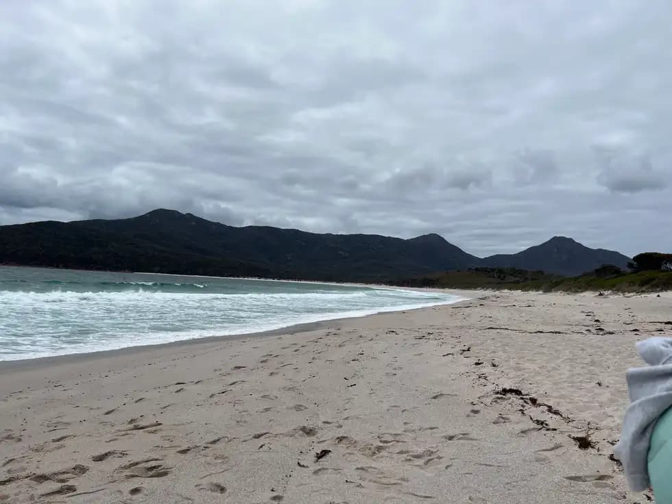 White sandy beach with The Hazards mountain range in the background