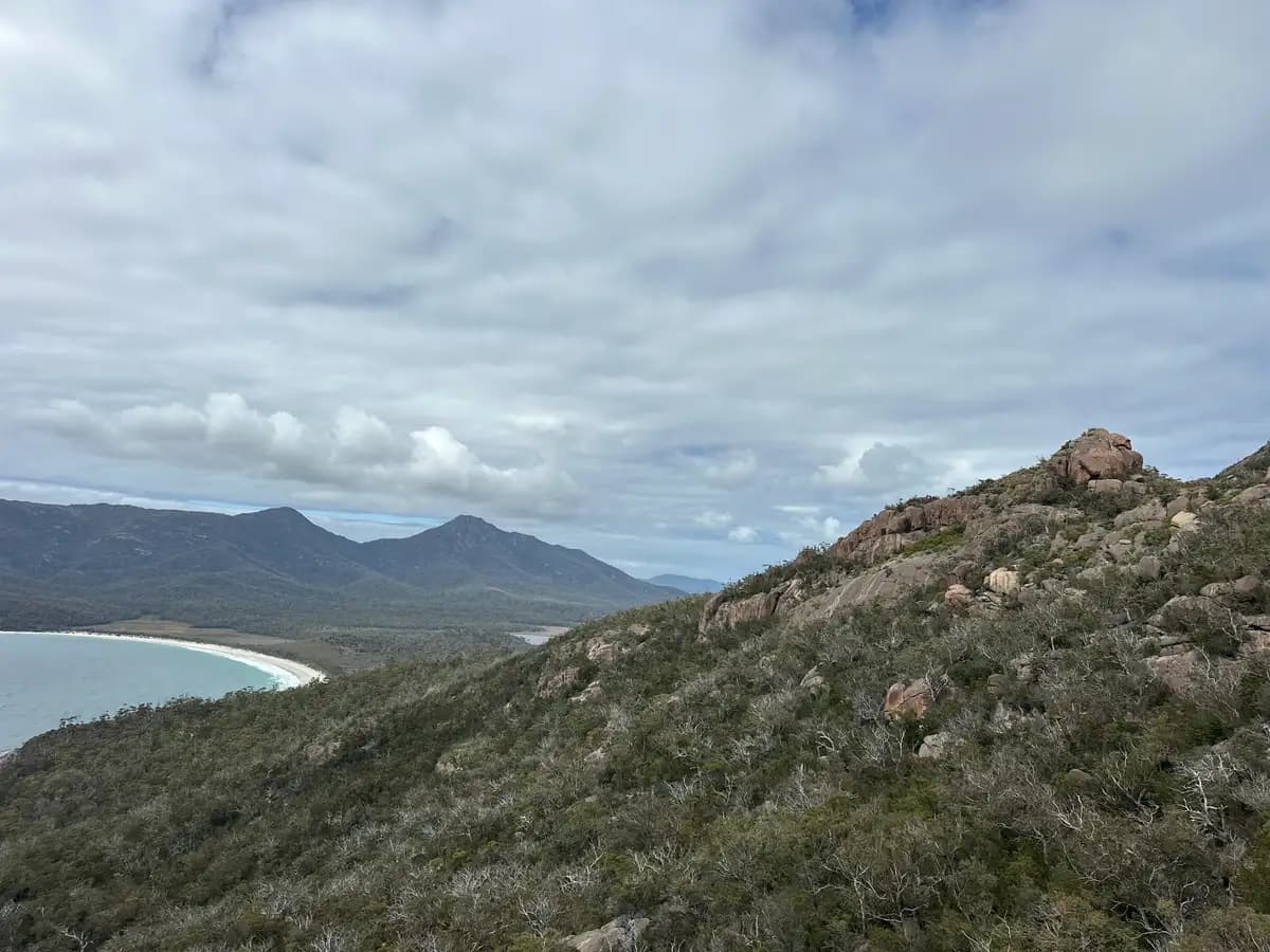 Wineglass Bay and Mount Amos ridge with pink granite boulders