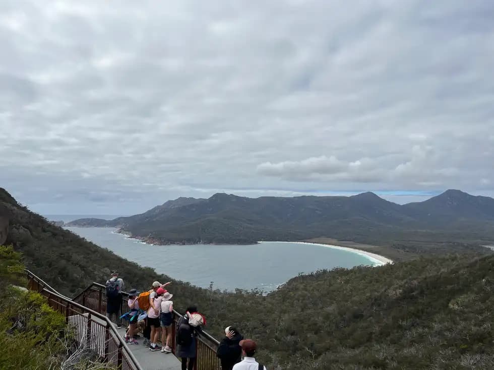 Visitors at the Wineglass Bay lookout platform overlooking the bay and mountains